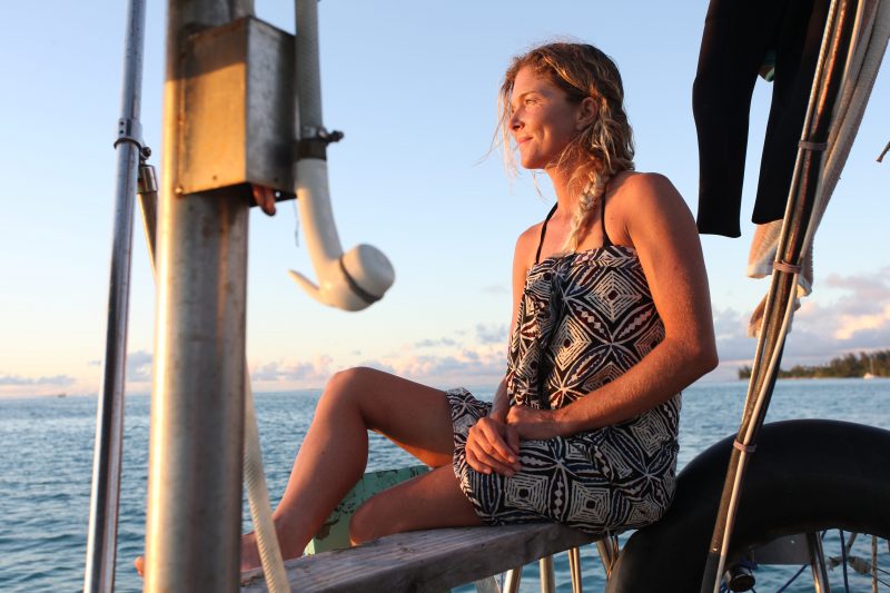 a girl from swell voyage sailing stories sitting in her sailboat
