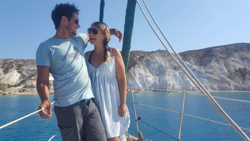 a couple on a sailboat laughing