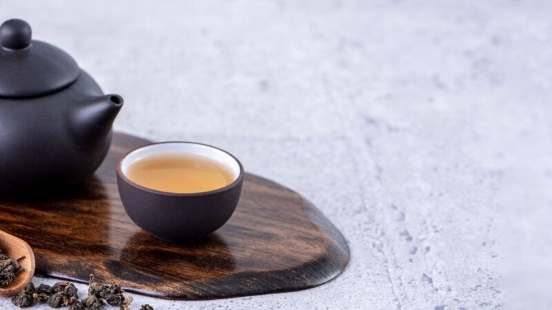 a cup of sri lankan tea and a tea pot