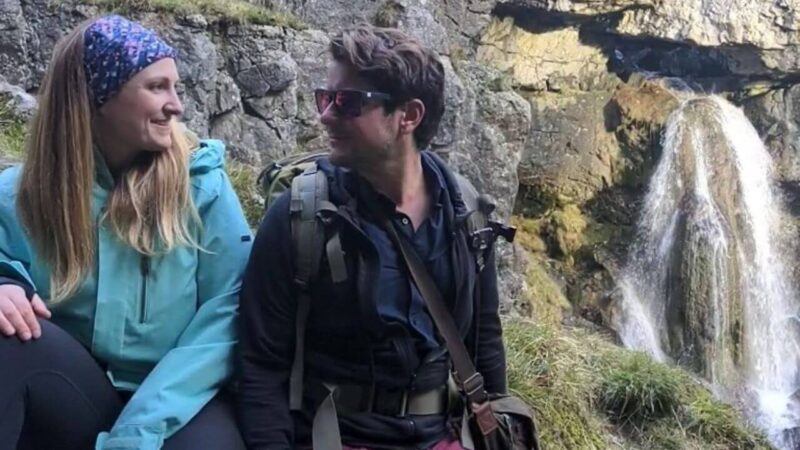 a couple relaxing by Gordale Scar waterfall