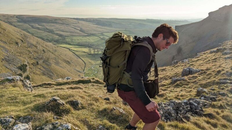a man hiking the malham cove walk