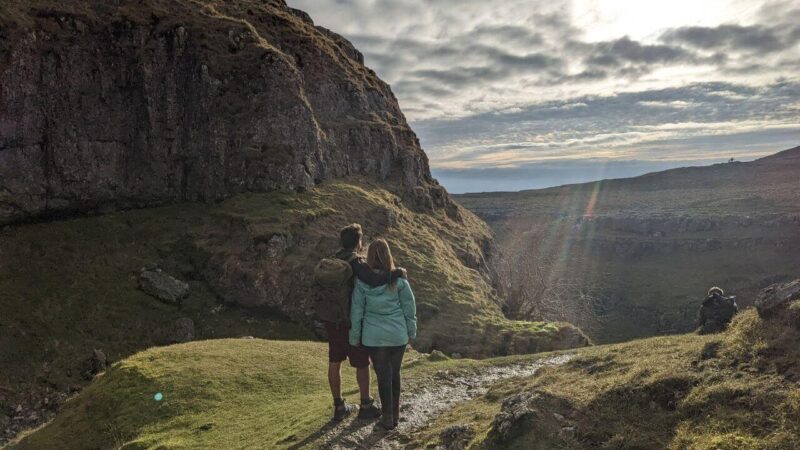 a couple standing in a view across gordale scar