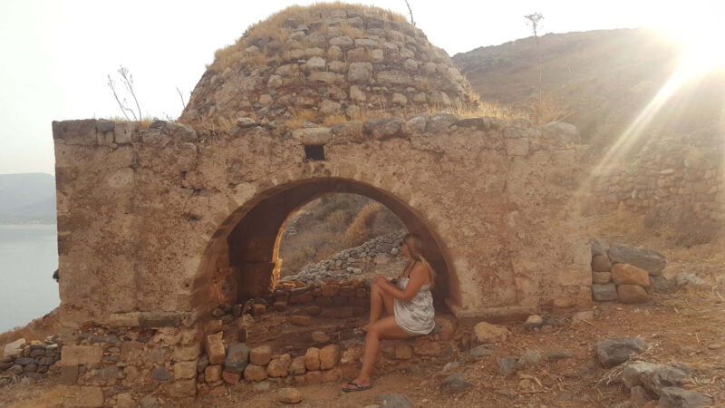 a girl sat on her own in monemvasia, greece