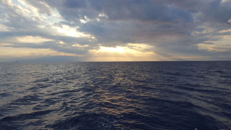 a sunset over a sea