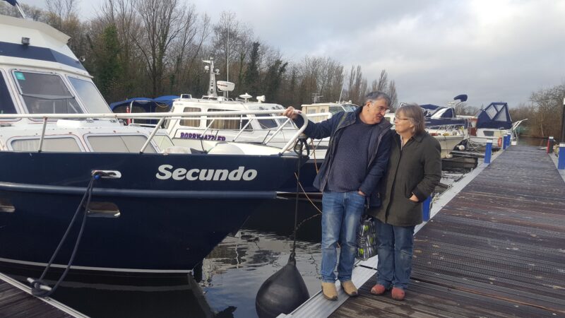 a couple beside a motor boat