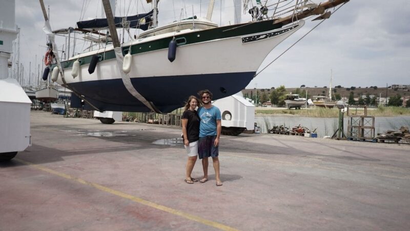 a liveaboard couple beside their sailboat