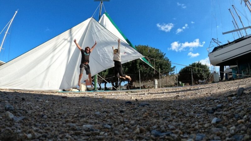 a couple who have read the best liveaboard books for rigging and are jumping by their sails