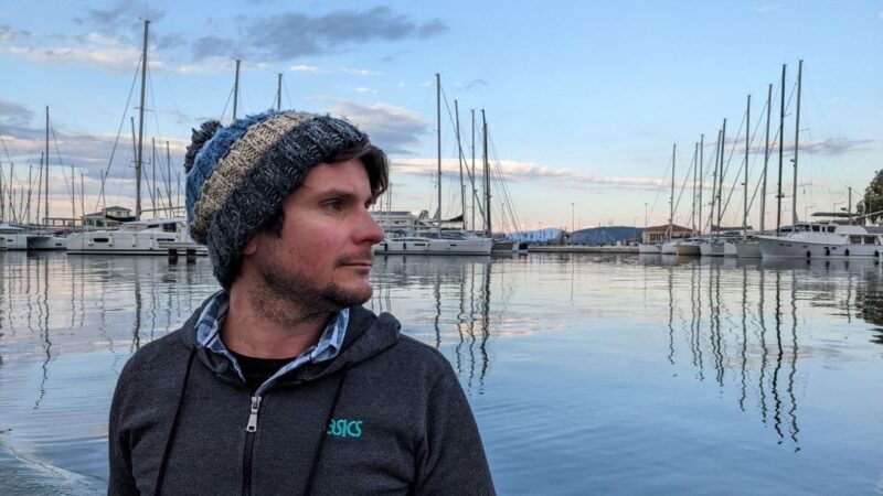 a man motoring through a liveaboard marina