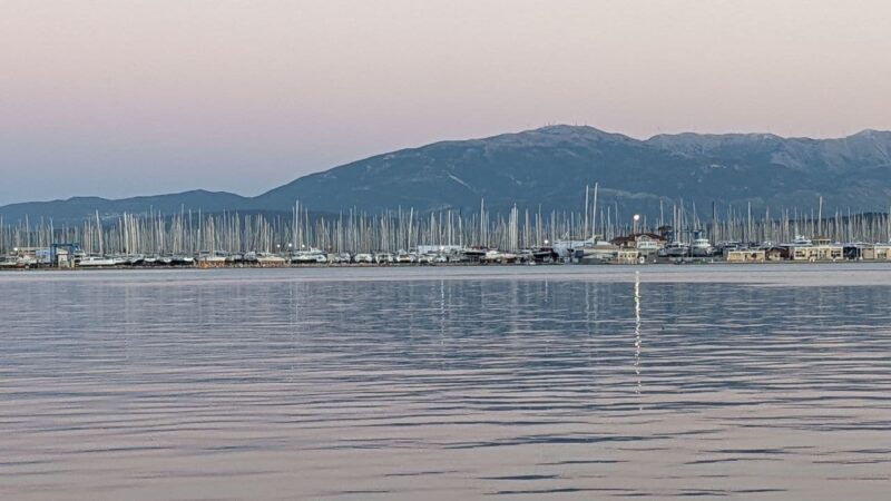 a liveaboard marina with the mountains behind