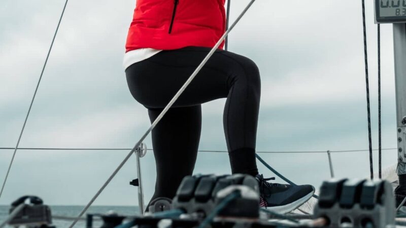 a girl on a sailboat wearing modern sailing shoes