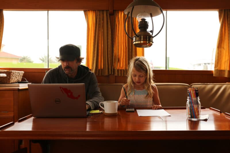 Pat making money while living aboard a trawler in the caribbean, with his daughter working next to him.