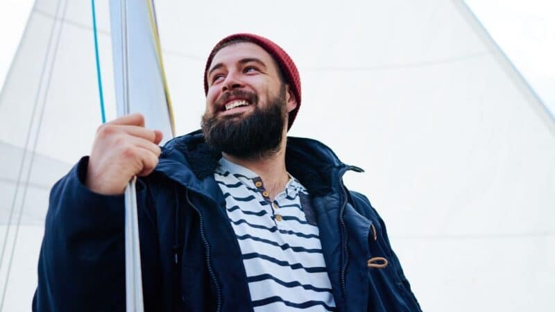 a man in lots of layers for winter sailing