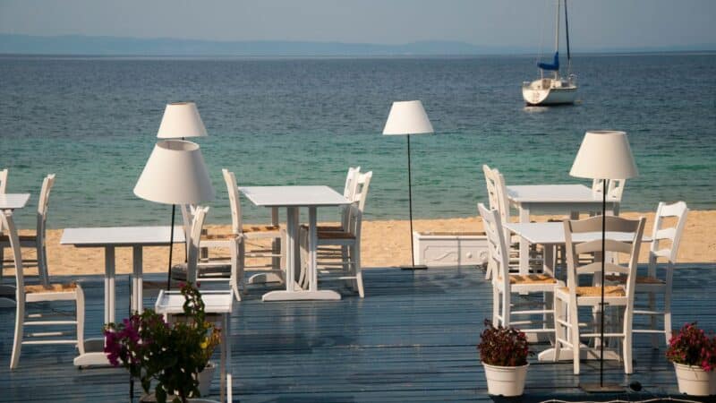 tables set up for dinner on a Greek beach