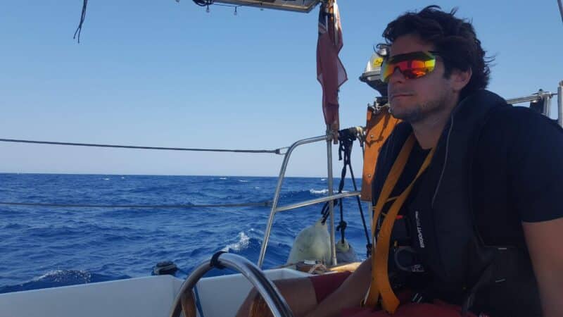 a man wearing a lifejacket sailing across the atlantic