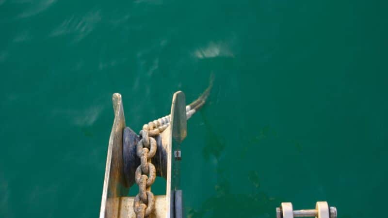 an anchor chain going down into the sea