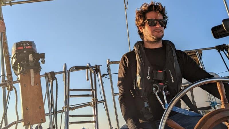 a man tethered in to a sailboat