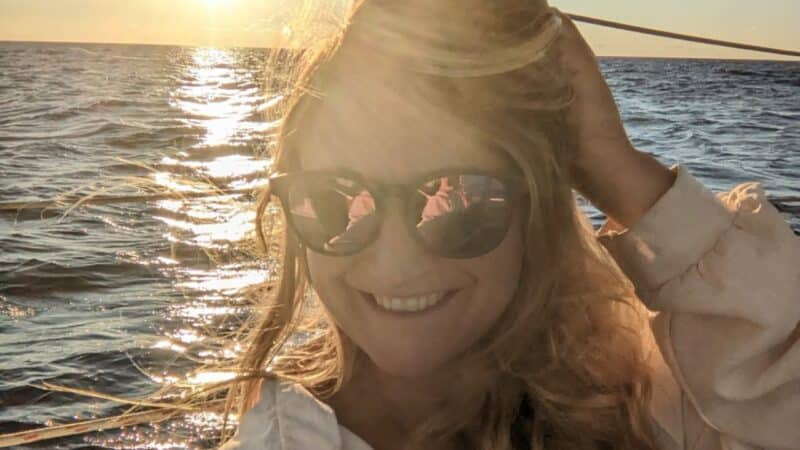 a girl on a sailboat smiling