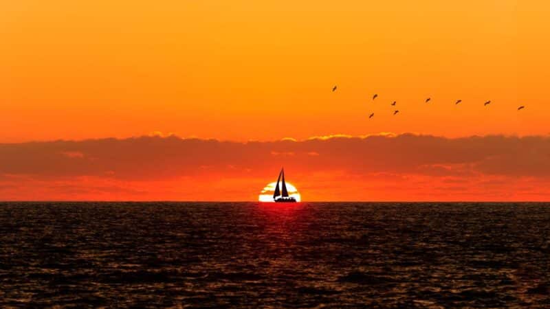 a sailboat in the sunset