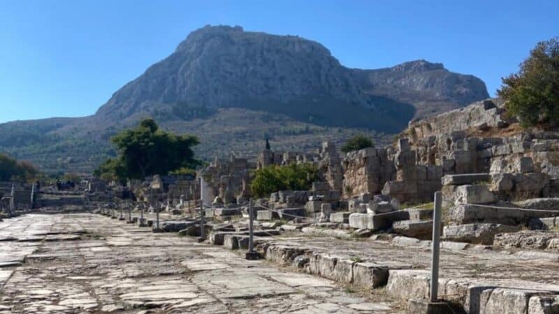 a beautiful view of athens ruins with the mountains behind
