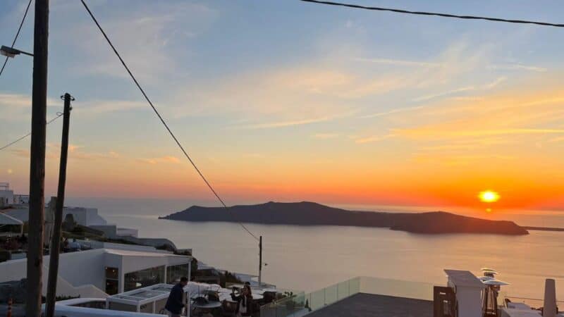 a sunset view of the sea and islands of santorini