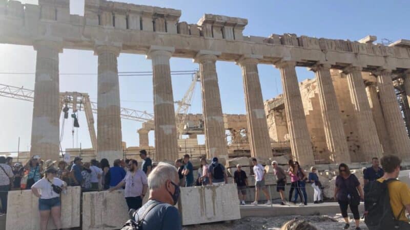 lots of people at some ruins in athens
