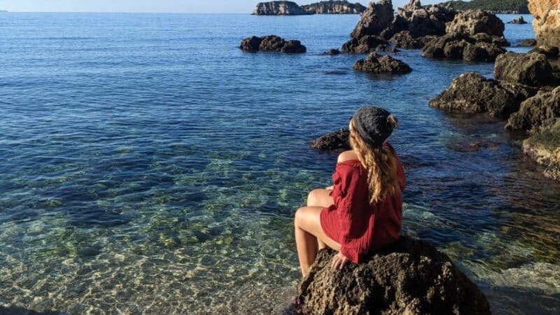 a girl looking out to the ocean thinking about sea related quotes