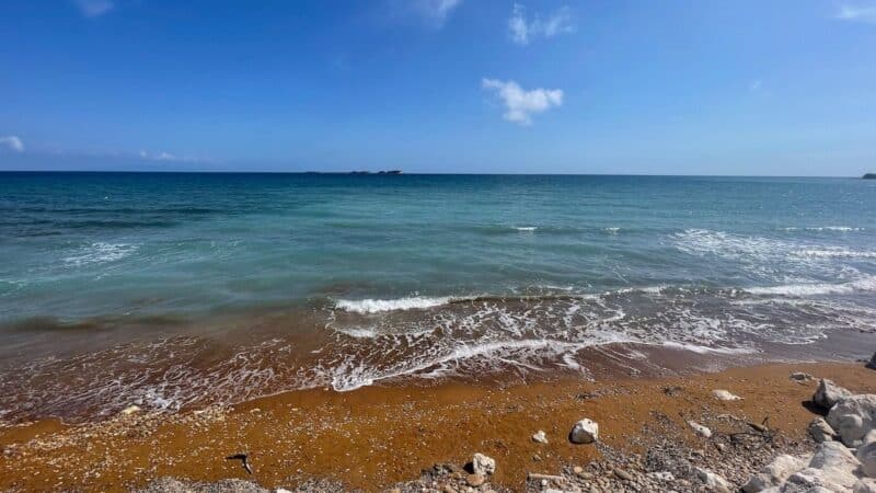 a beautiful beach with the sea lapping the rocks