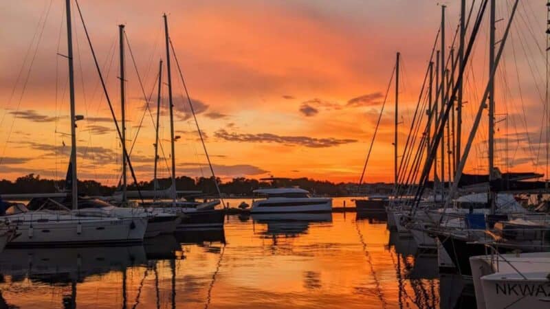 the sunset in a marina where someone is telling the best sailing stories