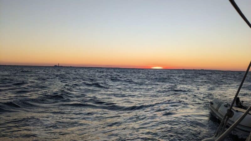 the sun dipping down below the horizon