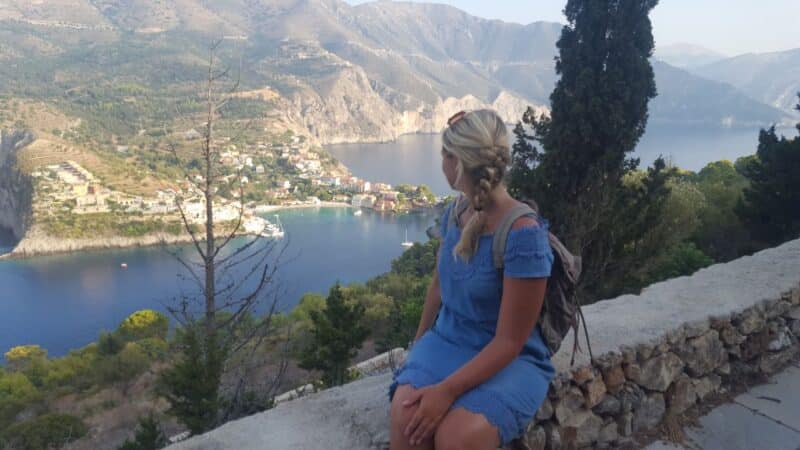 a girl looking at a pretty view thinking about the best greece captions for instagram