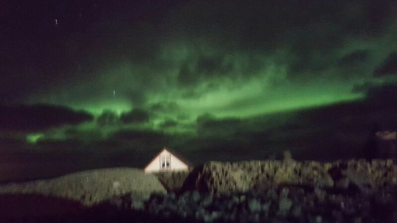 a blurry picture of the northern lights, seen in Iceland without a car