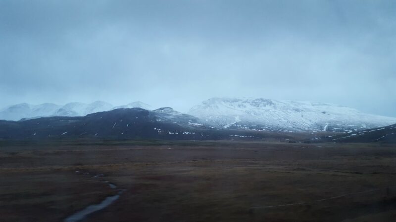 a view out of a coach window of incredible snowy scenes in Iceland