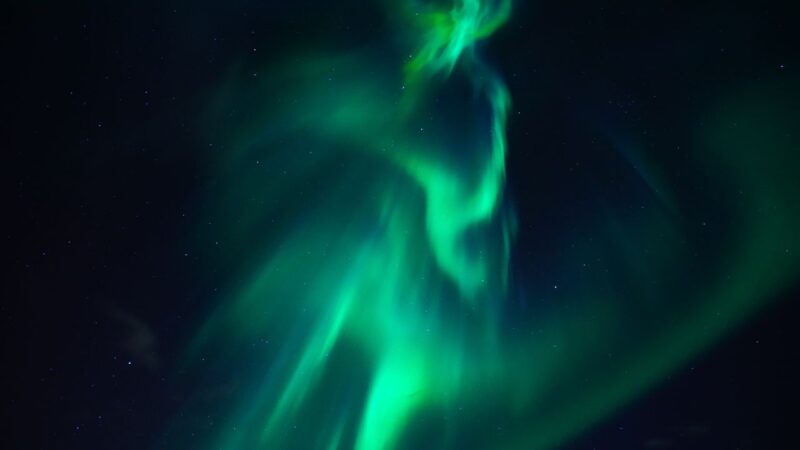 the beautiful green northern lights shining in icelands night sky